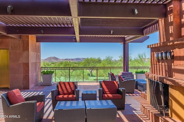 view of patio featuring an outdoor living space, a mountain view, and a pergola