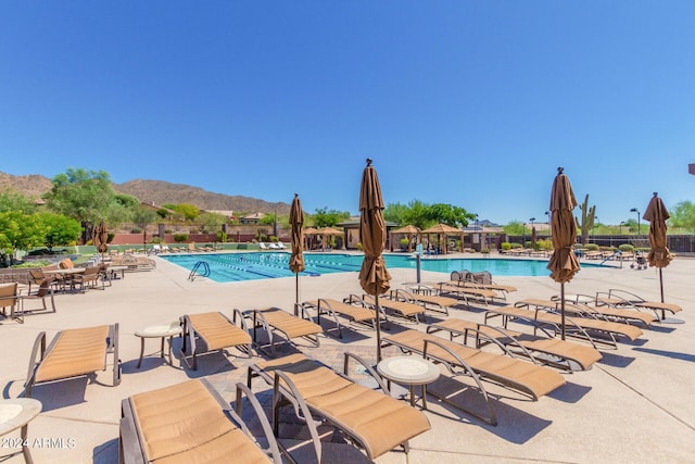 view of pool with a patio and a mountain view