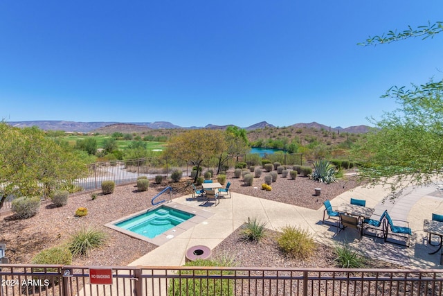 view of swimming pool with a mountain view and a patio