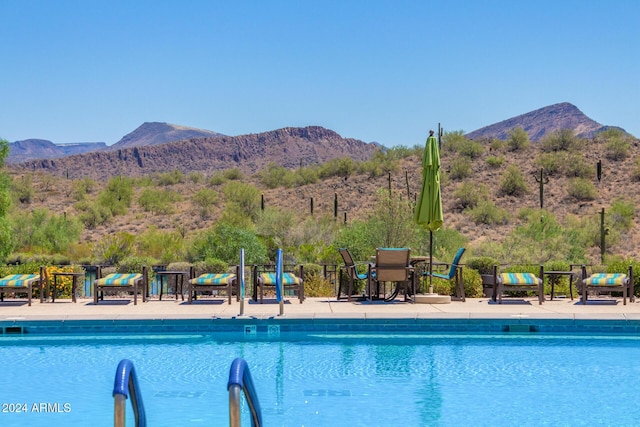 view of swimming pool featuring a mountain view