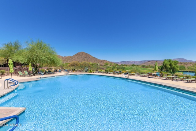 view of swimming pool featuring a mountain view and a patio