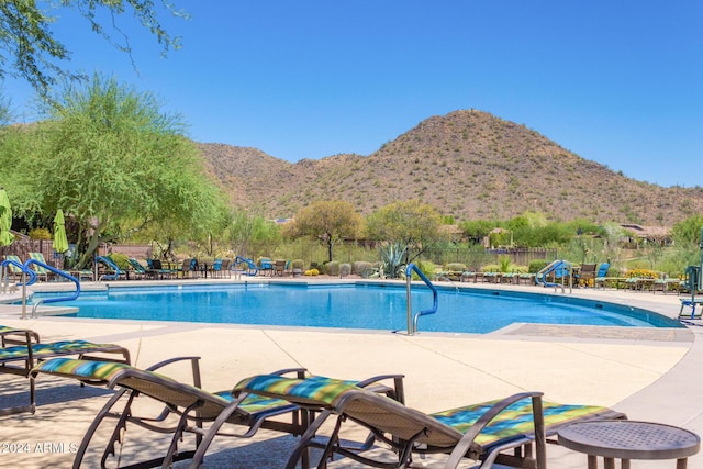 view of pool with a mountain view and a patio