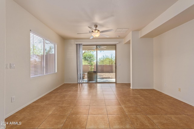 spare room featuring light tile patterned floors and ceiling fan