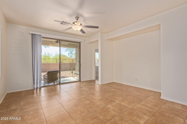 tiled empty room with ceiling fan