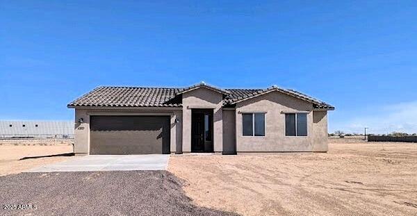 6262 S Dean Rd, Buckeye, AZ 85326 - ranch-style house with a garage, driveway, stucco siding, and a tiled roof