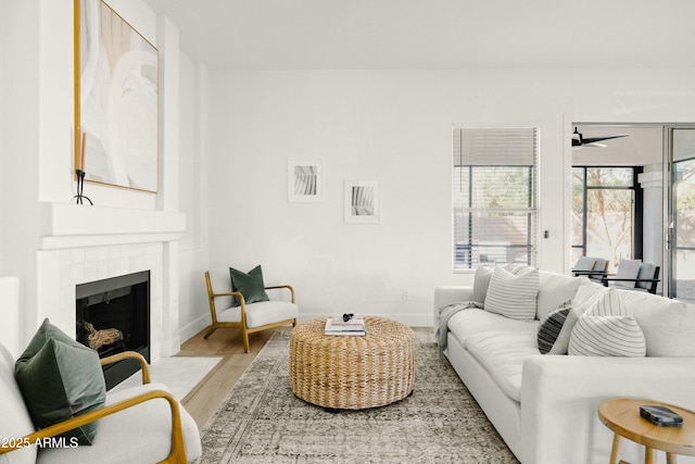 living room featuring hardwood / wood-style floors and a tile fireplace