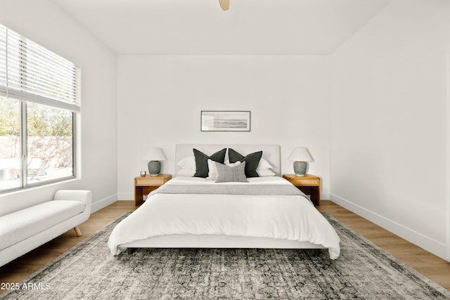 bedroom with wood-type flooring and ceiling fan