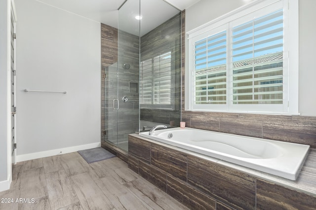 bathroom featuring hardwood / wood-style flooring and independent shower and bath