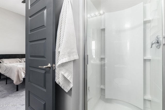 bathroom with a shower with door