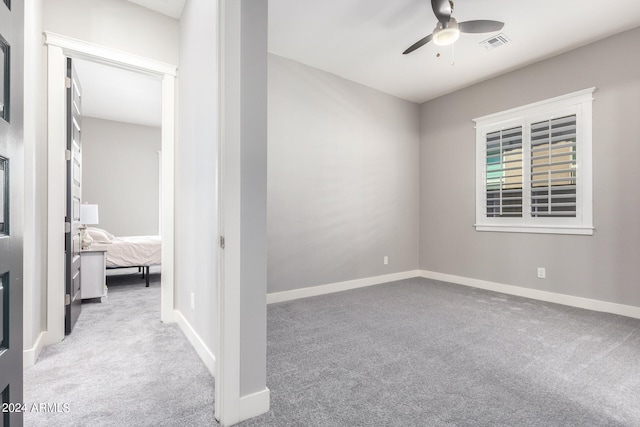 carpeted empty room with ceiling fan