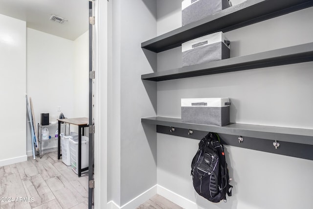 laundry area with hardwood / wood-style floors