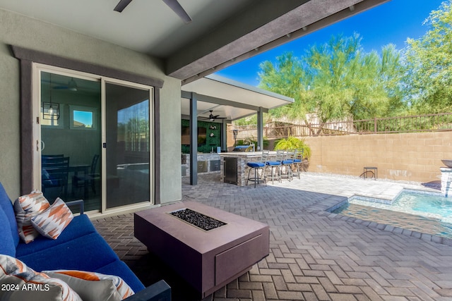 view of patio with an outdoor fire pit