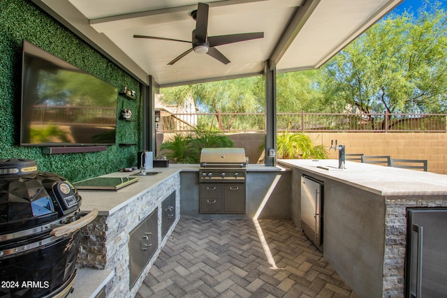 view of patio / terrace featuring area for grilling, sink, and ceiling fan