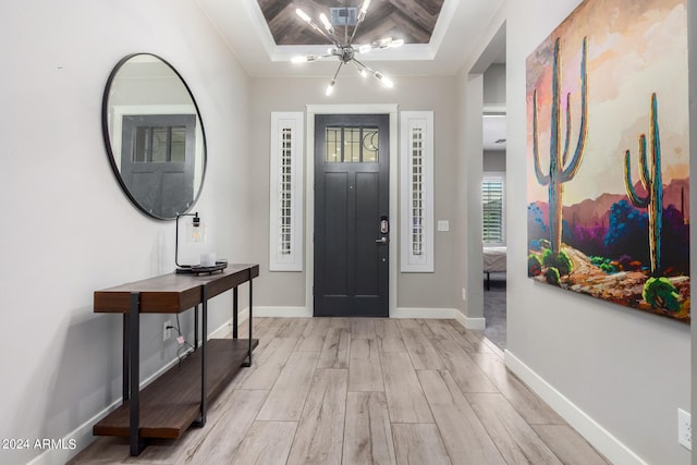 foyer entrance featuring light hardwood / wood-style flooring and an inviting chandelier