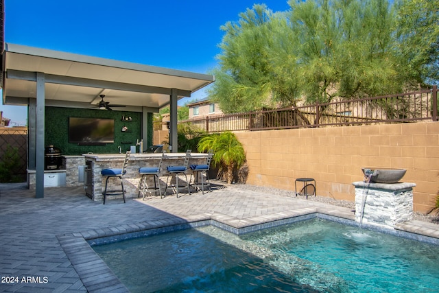 view of pool featuring area for grilling, pool water feature, ceiling fan, and a patio area