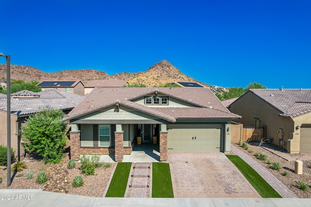 view of front of property with a mountain view and a garage