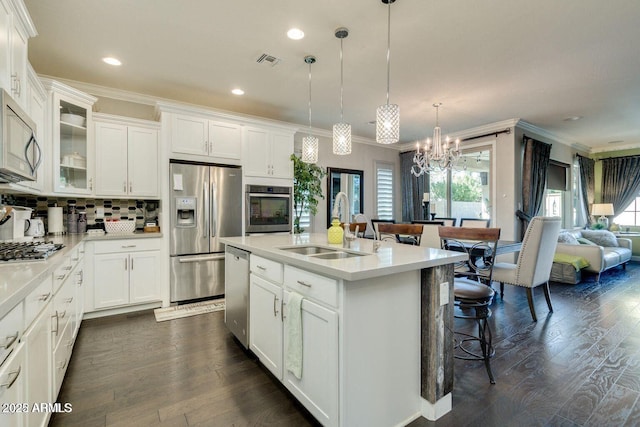 1952 W Yellowstone Way, Chandler, AZ 85248 - kitchen featuring appliances with stainless steel finishes, a sink, ornamental molding, light countertops, and white cabinets