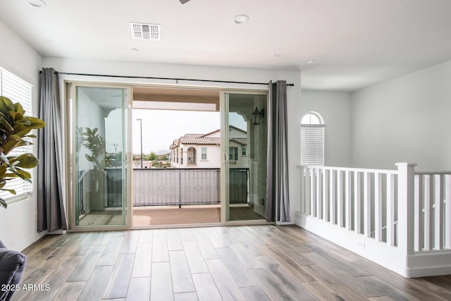 4063 E Amoroso Dr, Gilbert, AZ 85296 - empty room with plenty of natural light, wood finished floors, recessed lighting, and baseboards