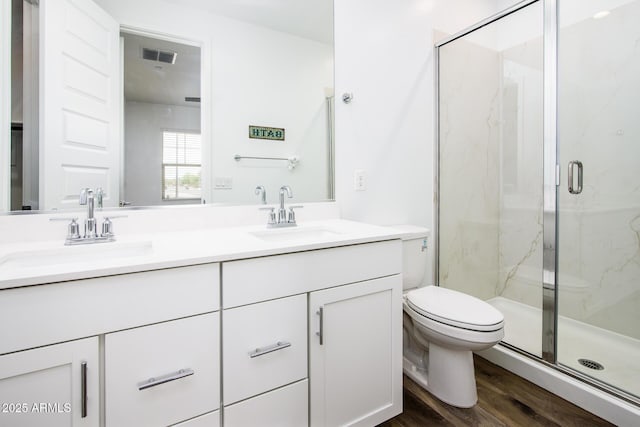 4063 E Amoroso Dr, Gilbert, AZ 85296 - full bathroom with a marble finish shower, double vanity, toilet, and wood finished floors