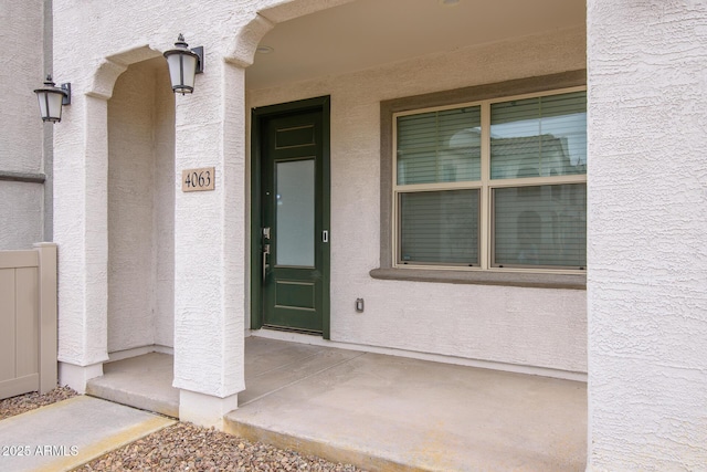 4063 E Amoroso Dr, Gilbert, AZ 85296 - view of exterior entry with stucco siding and a porch