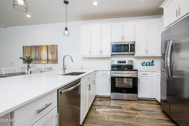 4063 E Amoroso Dr, Gilbert, AZ 85296 - kitchen featuring appliances with stainless steel finishes, a sink, white cabinets, light countertops, and recessed lighting