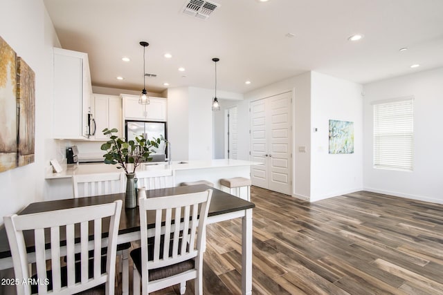 4063 E Amoroso Dr, Gilbert, AZ 85296 - dining space featuring recessed lighting, dark wood-type flooring, and baseboards