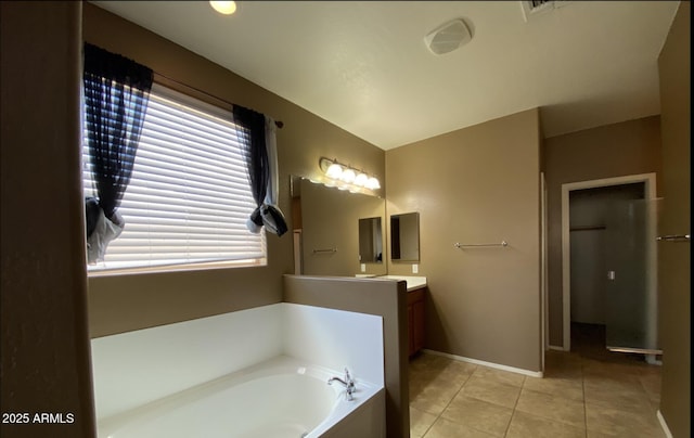 bathroom with tile patterned floors, vanity, and a bathtub