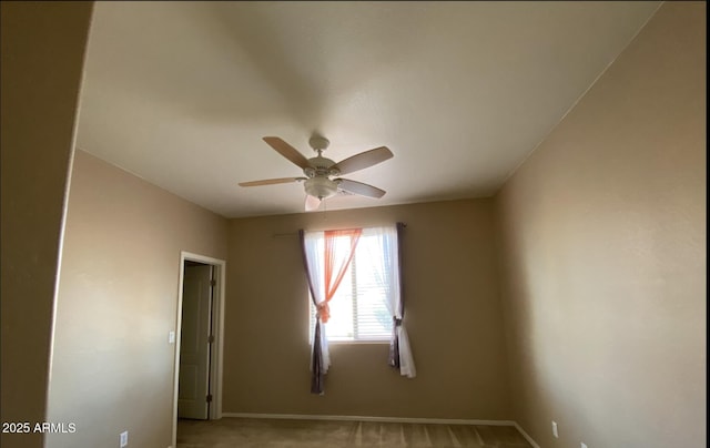 empty room featuring light colored carpet and ceiling fan