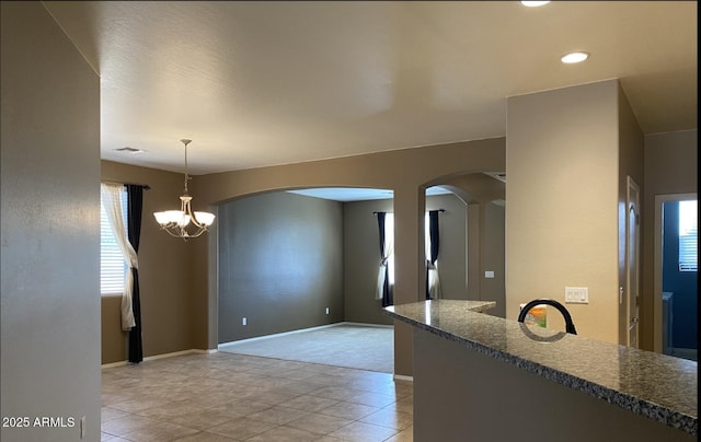 kitchen featuring an inviting chandelier, hanging light fixtures, and light tile patterned floors