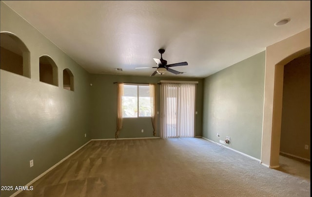 carpeted spare room with ceiling fan