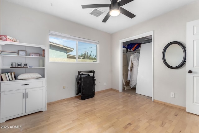 bedroom with ceiling fan, a closet, and light hardwood / wood-style floors