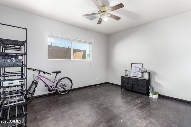 misc room featuring ceiling fan and dark hardwood / wood-style flooring