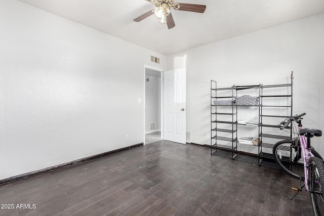 unfurnished bedroom featuring dark wood-type flooring and ceiling fan