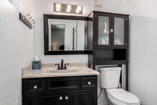 bathroom with toilet and vanity