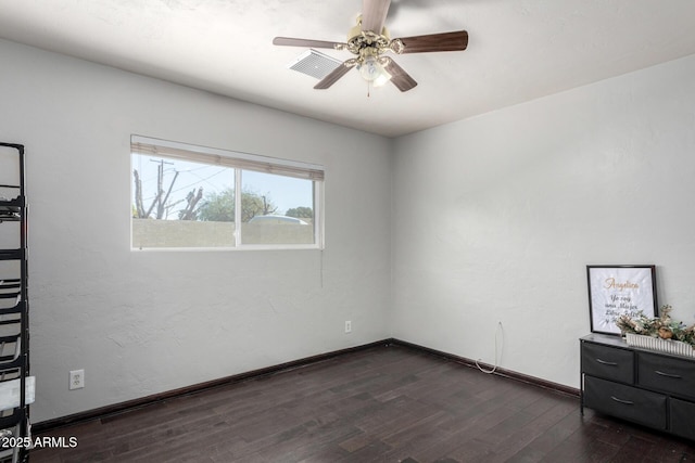 spare room featuring ceiling fan and dark wood-type flooring