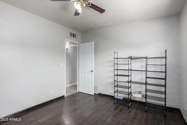 unfurnished bedroom with dark wood-type flooring and ceiling fan