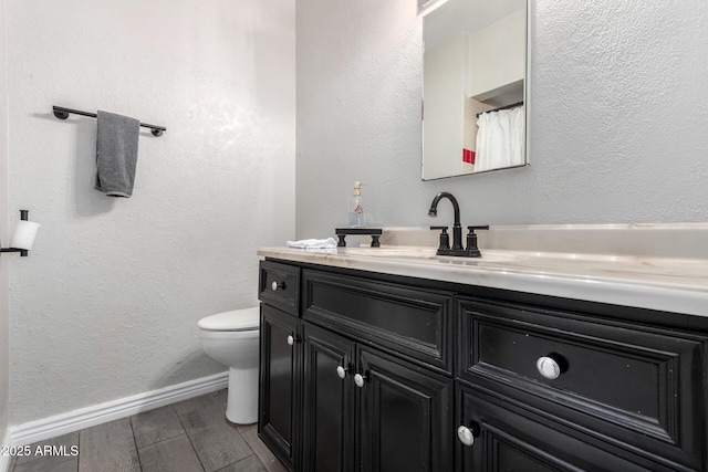 bathroom with toilet and vanity