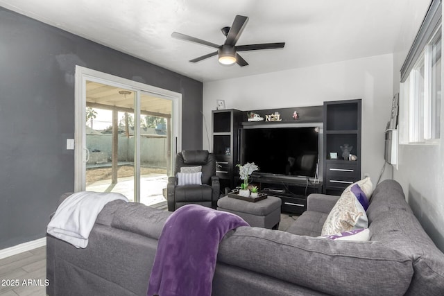 living room featuring ceiling fan and hardwood / wood-style flooring