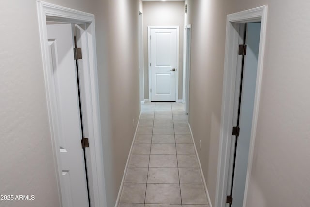 hall featuring light tile patterned floors