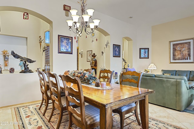 dining space featuring light tile patterned floors and an inviting chandelier