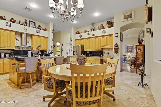 dining area featuring light tile patterned floors and a chandelier