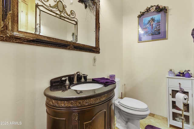 bathroom featuring vanity, tile patterned flooring, and toilet