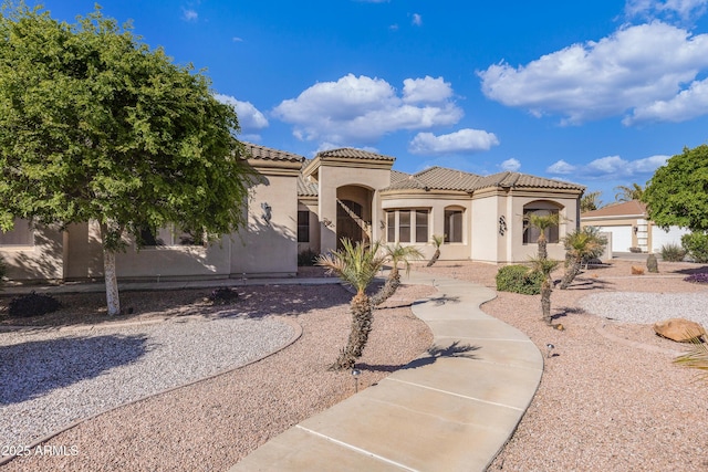 mediterranean / spanish home featuring a garage