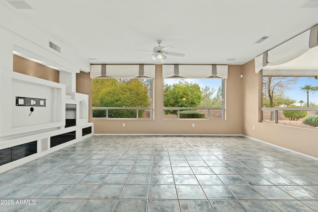 unfurnished living room featuring ceiling fan and light tile patterned floors