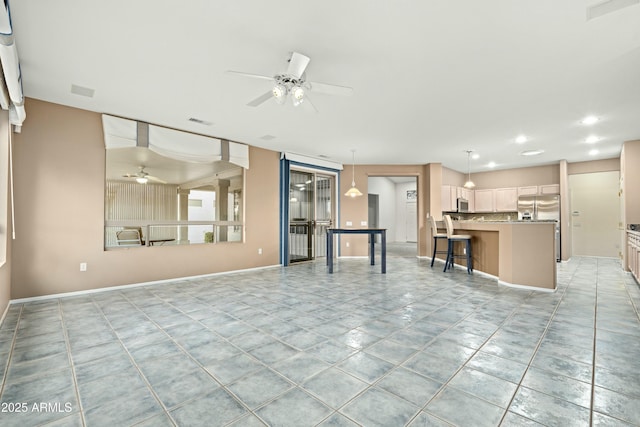 unfurnished living room with ceiling fan and light tile patterned floors