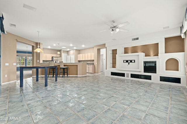 living room with ceiling fan, light tile patterned floors, and built in features