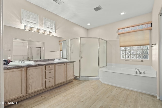 bathroom with plus walk in shower and vanity