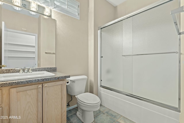 full bathroom featuring tile patterned floors, shower / bath combination with glass door, vanity, and toilet