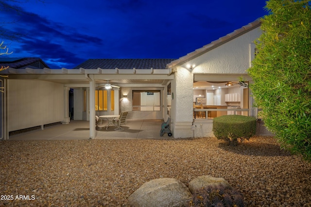 back house at night with a patio