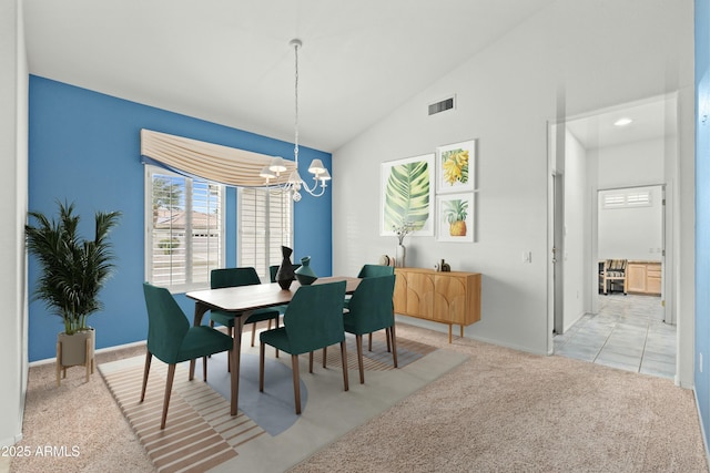 dining area with an inviting chandelier, lofted ceiling, and light colored carpet